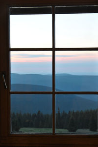 Scenic view of mountains seen through window