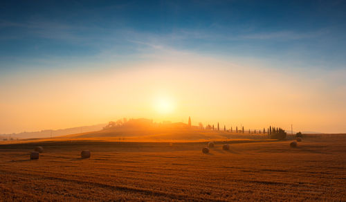 Scenic view of field against sky during sunset
