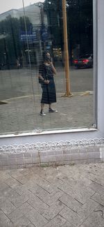 Rear view of woman walking on street in city