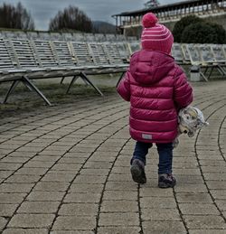 Rear view of girl walking outdoors