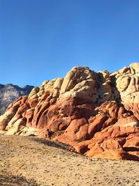 Rock formations against clear blue sky