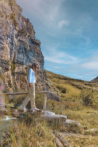 Young tourist walks on a path to the mountain. adventure travel, hiking concept.