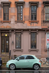 Car on street against buildings