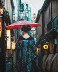 Rear view of a woman walking in city