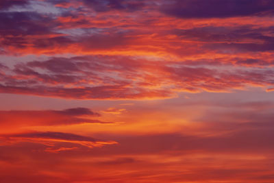 Pink purple orange clouds in sunset sky, full frame