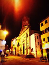 Illuminated buildings against sky at night