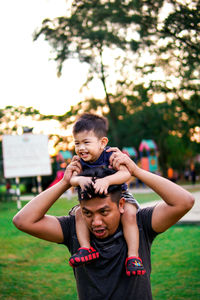 Portrait of father and son on plant