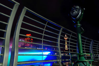 Low angle view of illuminated city against sky at night