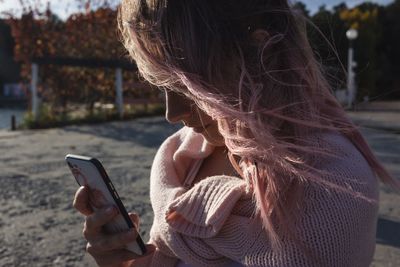 Midsection of woman using mobile phone