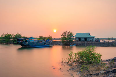 Scenic view of lake against sky during sunset