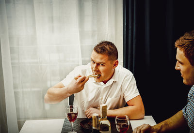 Young man sitting at table