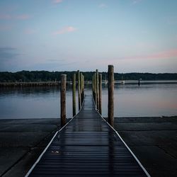 Pier over lake against sky