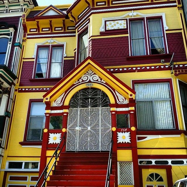 architecture, built structure, building exterior, window, low angle view, arch, yellow, facade, entrance, door, building, residential building, residential structure, outdoors, no people, day, ornate, balcony, place of worship, house