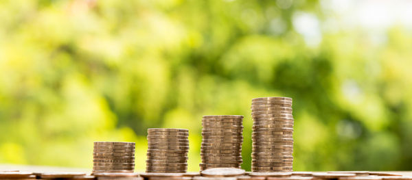 Close-up of coins stacked on table