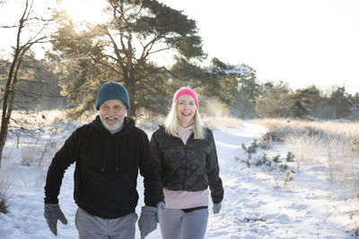 Happy couple walking together on snow