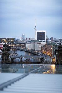 Illuminated buildings in city at dusk