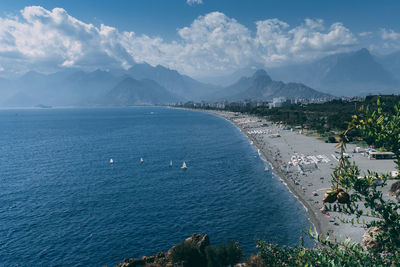 High angle view of townscape by sea against sky