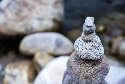 Close-up of stone stack on rock at beach