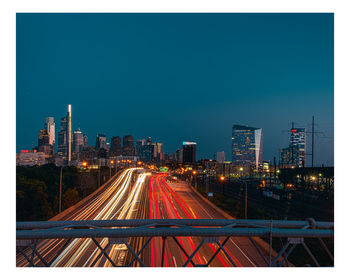 High angle view of illuminated cityscape against sky at night