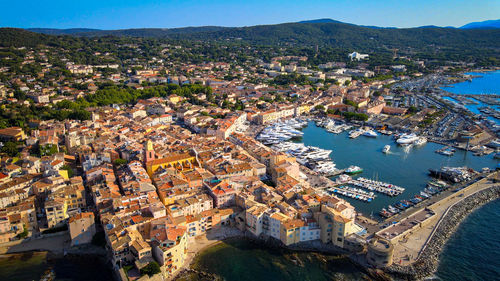 High angle view of townscape by sea against sky