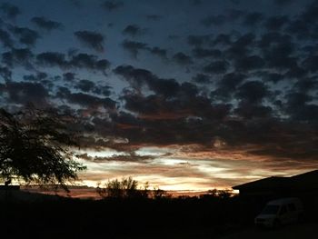 Low angle view of silhouette trees against sky at sunset