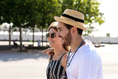 Happy couple of tourists walking in a city street