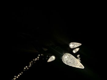 Close-up of illuminated lights over black background