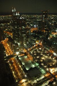 High angle view of illuminated buildings in city at night