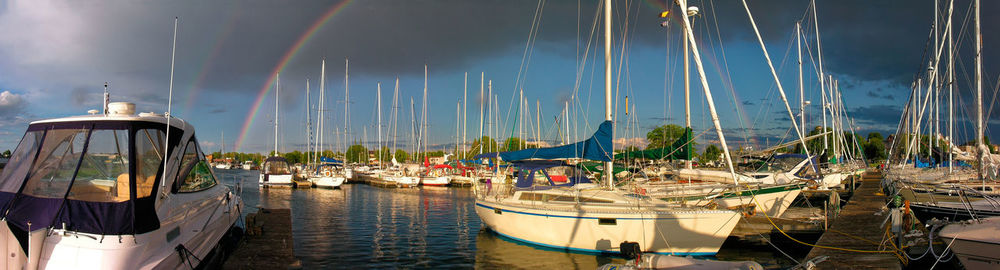 Sailboats moored in harbor