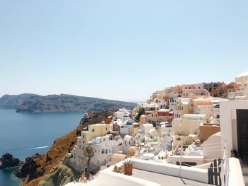 Townscape by sea against clear sky