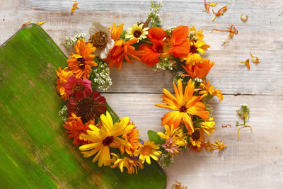 High angle view of flowering wreath on table for decoration in summer