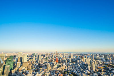 Aerial view of cityscape against clear sky during sunset