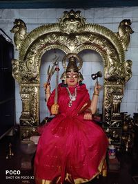 Portrait of smiling woman in statue