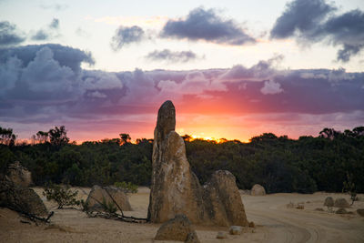 Scenic view of rocks against sky during sunset