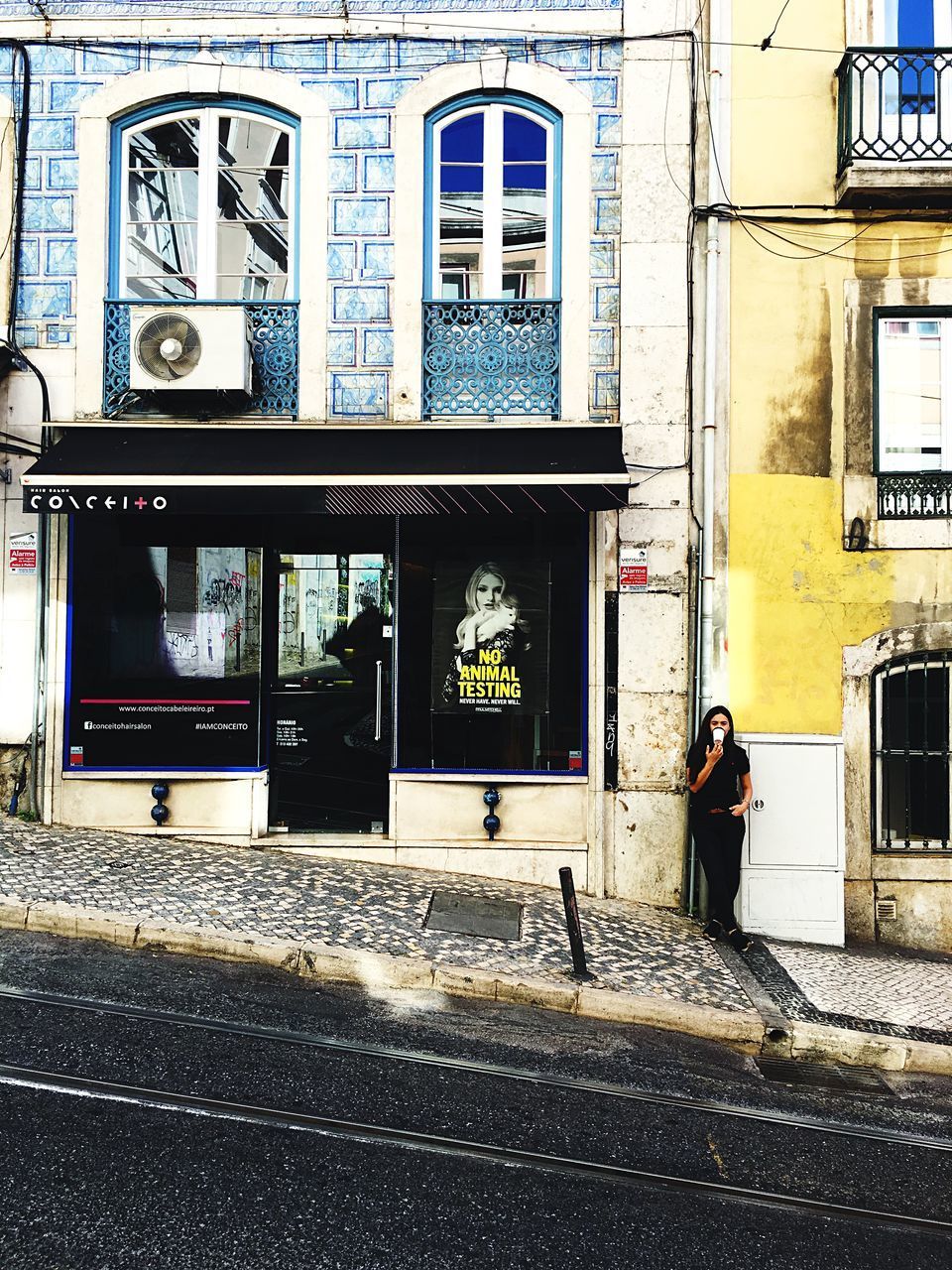 PEOPLE WALKING ON STREET AGAINST BUILDINGS