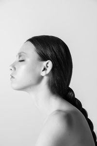 Close-up portrait of a young woman over white background