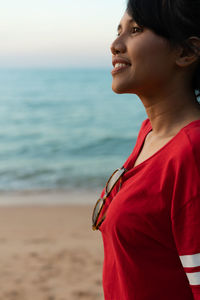 Woman looking away at beach
