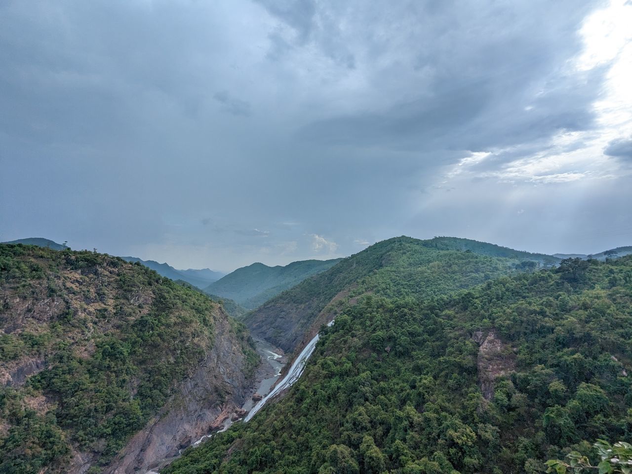 environment, cloud, sky, mountain, landscape, scenics - nature, nature, beauty in nature, land, plant, tree, no people, forest, travel, mountain range, travel destinations, outdoors, tranquility, tourism, non-urban scene, fog, valley, social issues, overcast, plateau, mountain pass, tranquil scene, ridge, environmental conservation, highland, architecture, day, high angle view, road, rural scene
