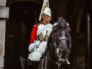 Portrait of man riding horse