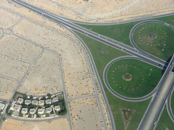 High angle view of airplane flying over road