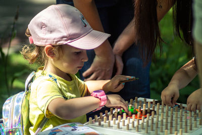 Girl playing with people on table