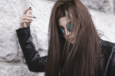 Close-up of young woman in sunglasses outdoors