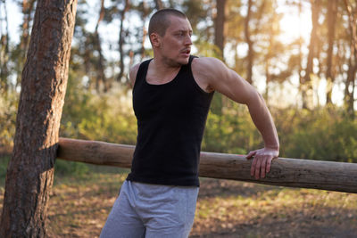 Full length of man standing by tree in forest