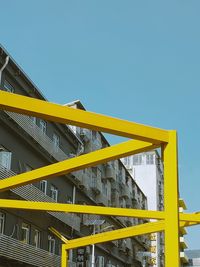 Low angle view of yellow building against clear sky