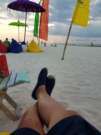 Low section of man relaxing on beach