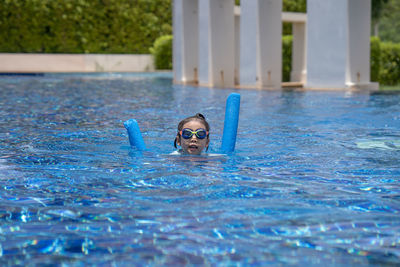 Portrait of boy swimming in pool