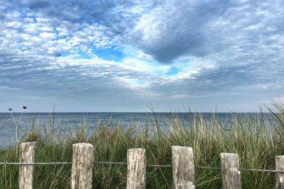 Scenic view of sea against cloudy sky