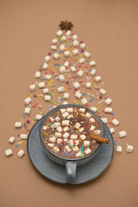 Conceptual winter tree from hot chocolate cup and marshmallows