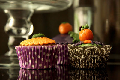 Close-up of halloween cupcakes on black background