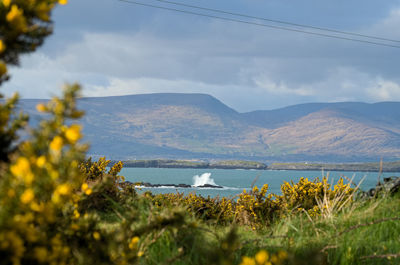 Scenic view of sea and mountains against sky